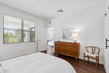 a bedroom with a bed and a dresser and a window at Odyssey, Florida